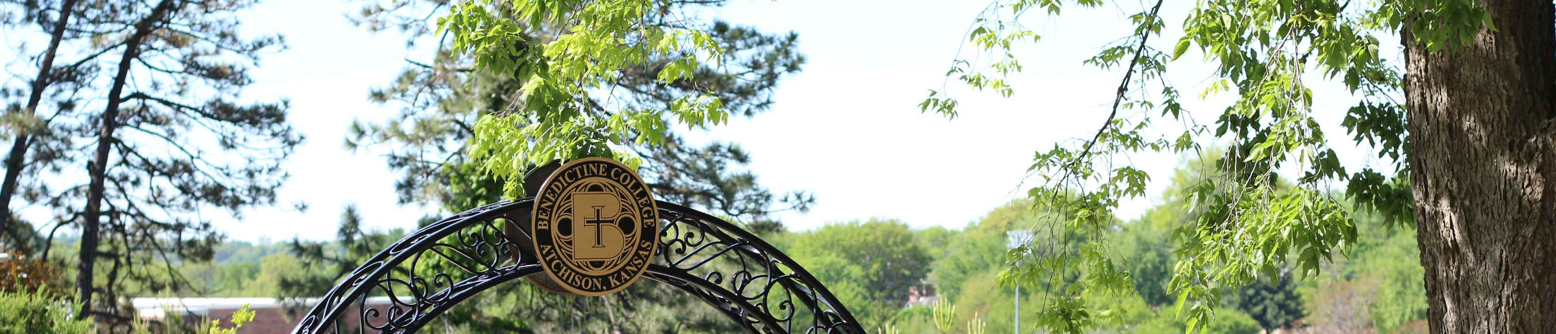 The Benedictine College Seal set atop the entry archway to Mary's Grotto
