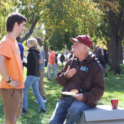 A student speaks to a man during Christ in the City in Denver