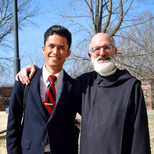 Fr. Gabriel Landis with a student