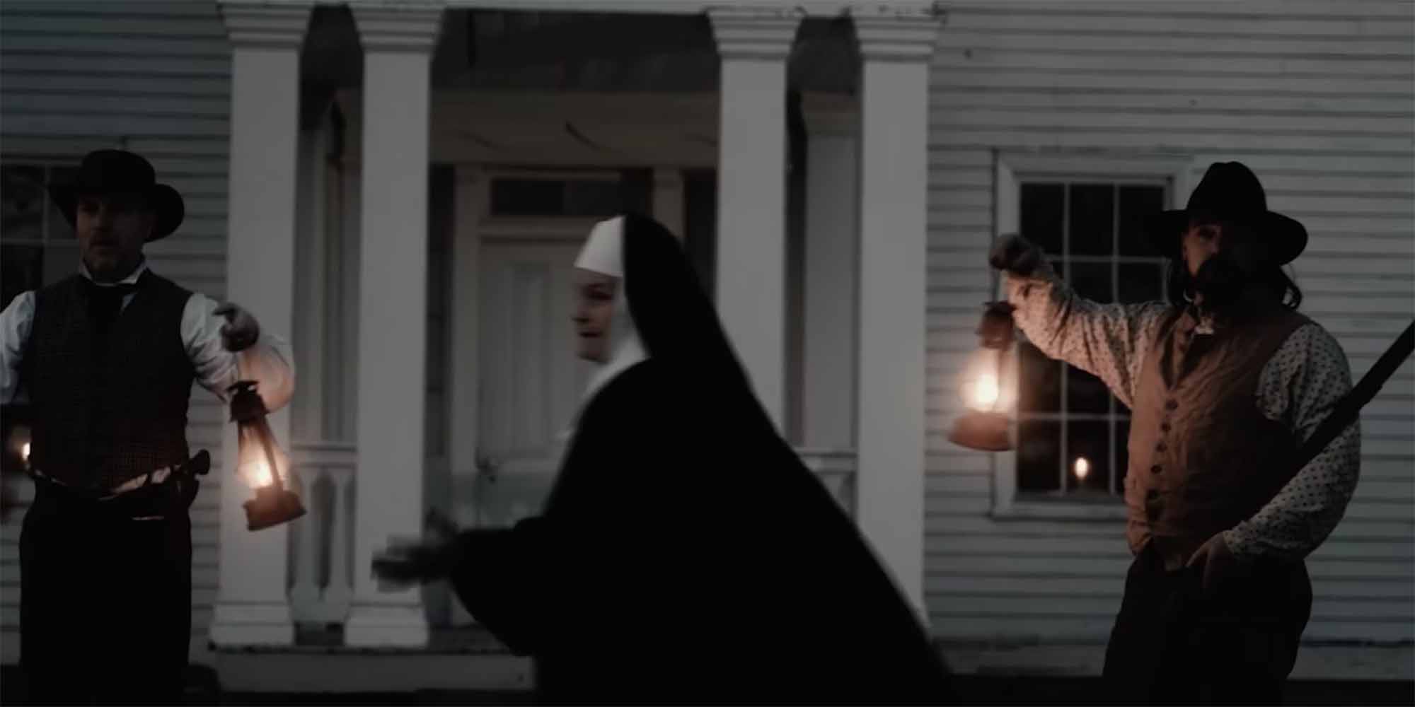 Men waving lanterns as a religious sister arrives