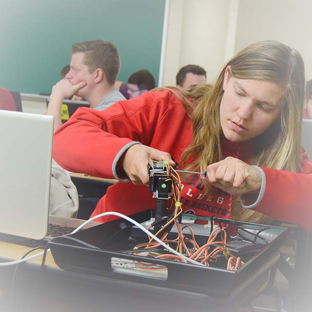 A student works with electronics in class