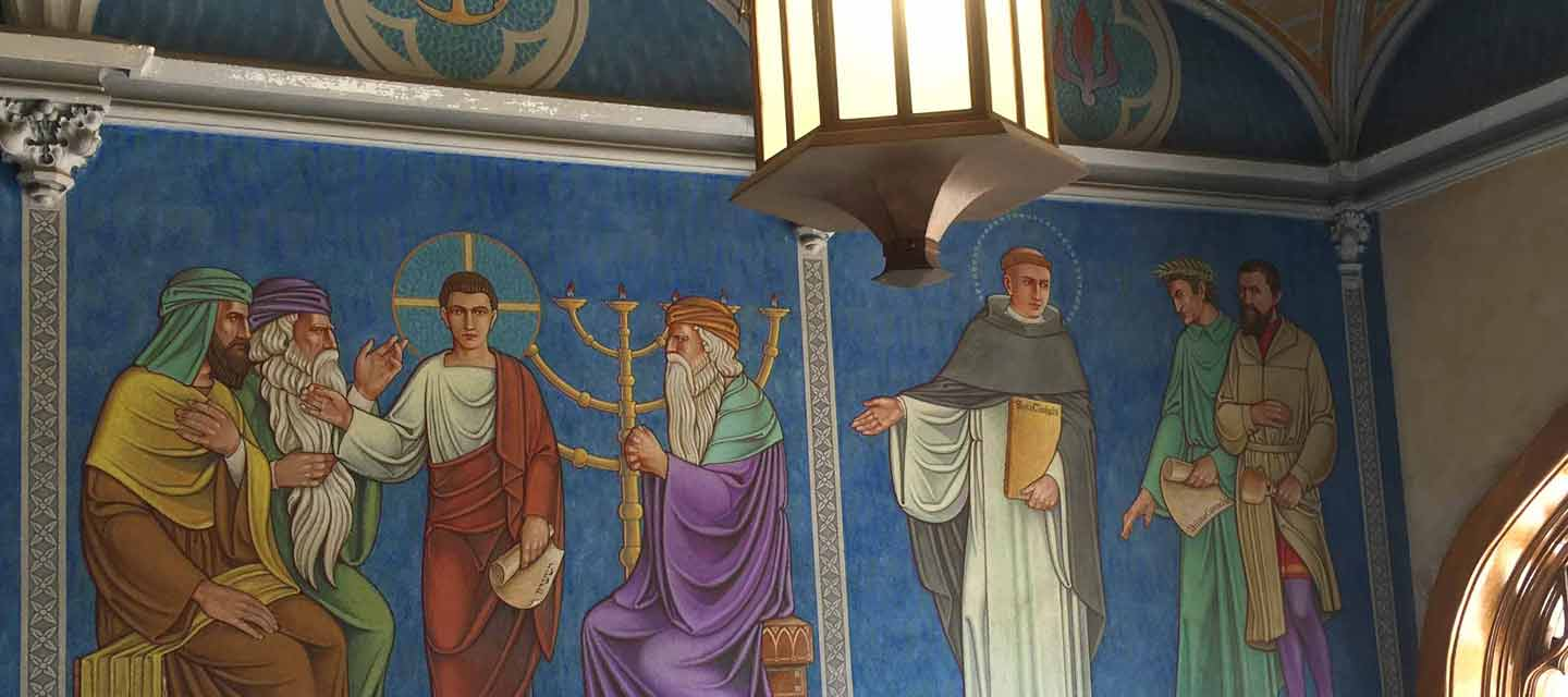 A wall mural depicting multiple historical and religious figures
