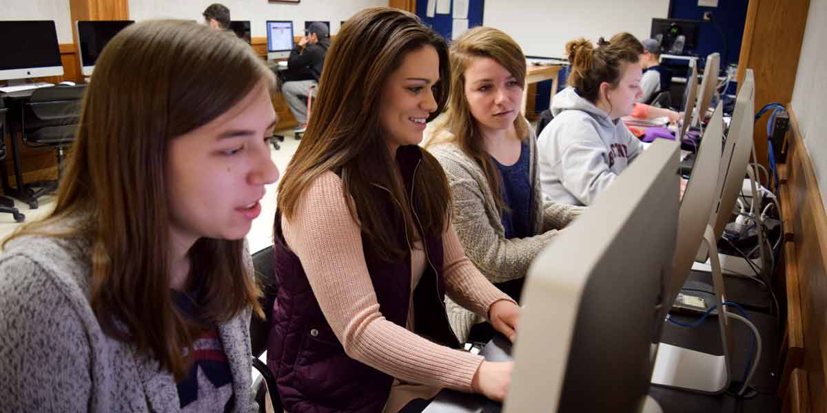 Students in class working at computer stations