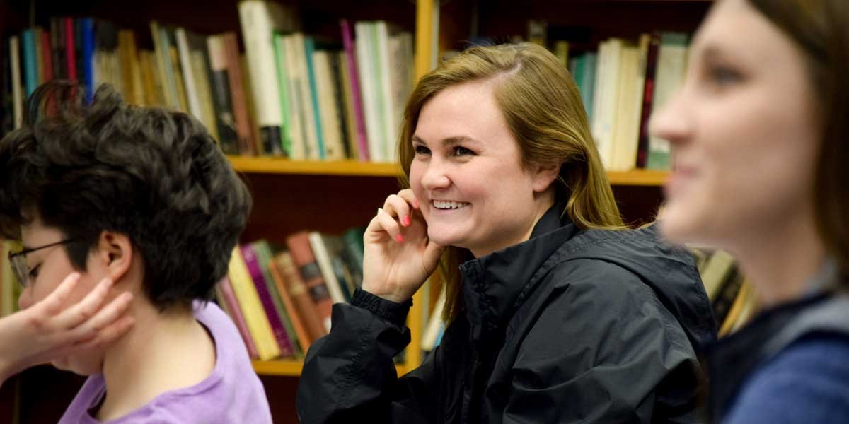 A student smiles in class