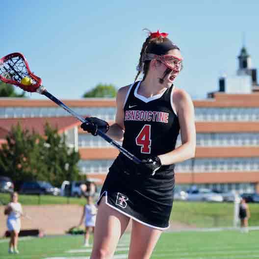 Lady Ravens lacrosse player looking to make a pass