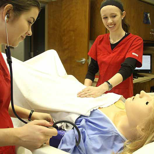 Nursing students practicing taking care of a patient