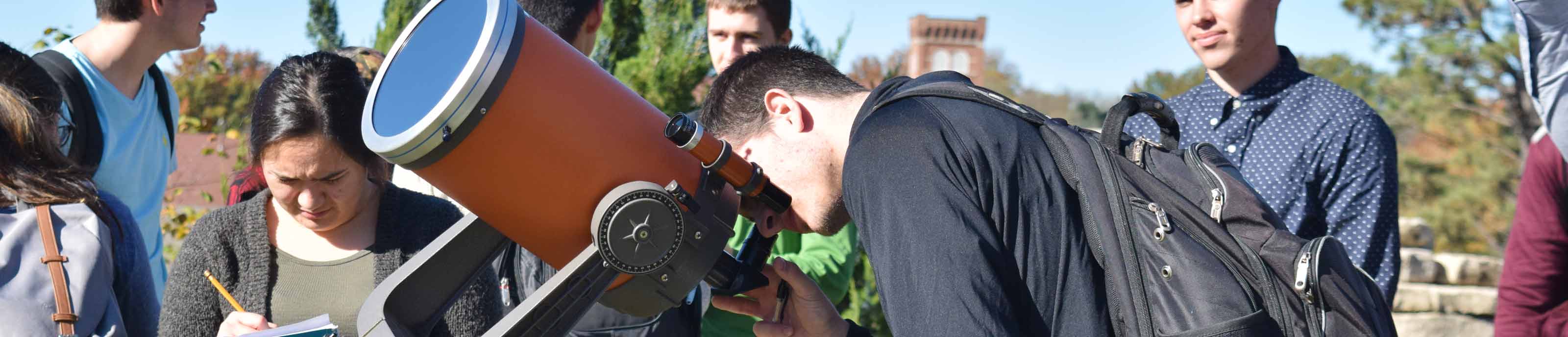 Students working with a telescope in Astronomy class