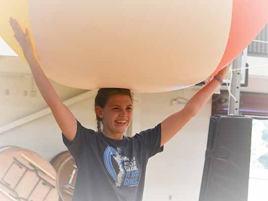 A BCYC participant holds a large inflated ball during a game