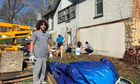 Students help with a house renovation