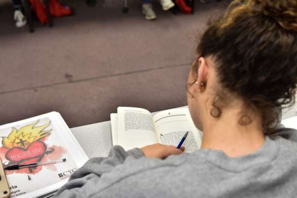 A student reads a book in class