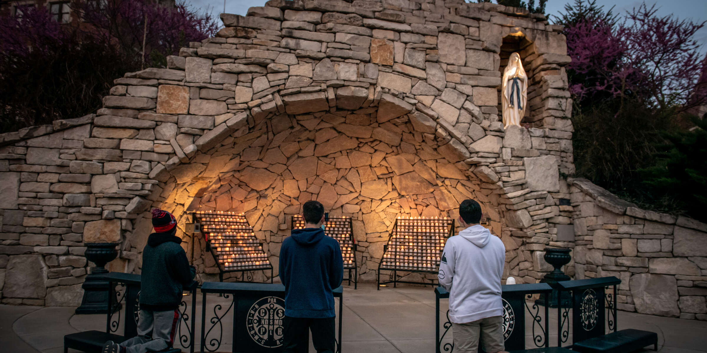 Students pray at Mary's Grotto